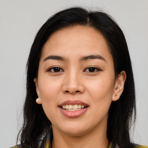 Joyful asian young-adult female with long  brown hair and brown eyes