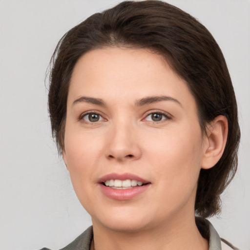 Joyful white young-adult female with medium  brown hair and brown eyes