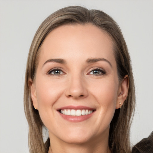 Joyful white young-adult female with long  brown hair and grey eyes