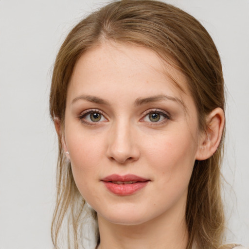 Joyful white young-adult female with medium  brown hair and grey eyes