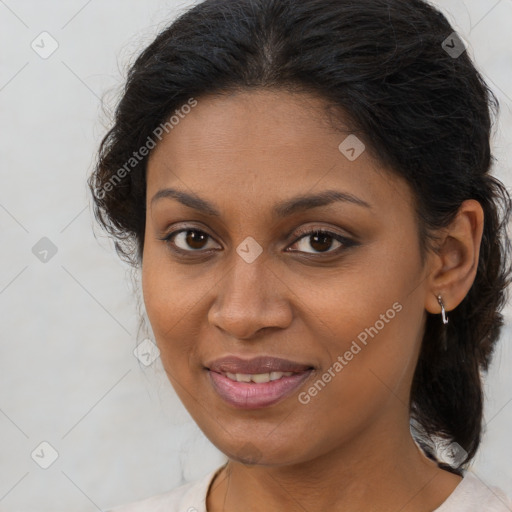 Joyful black young-adult female with medium  brown hair and brown eyes