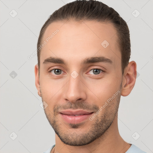 Joyful white young-adult male with short  brown hair and brown eyes