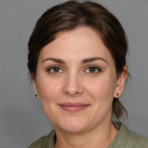 Joyful white adult female with medium  brown hair and grey eyes