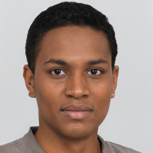 Joyful black young-adult male with short  black hair and brown eyes