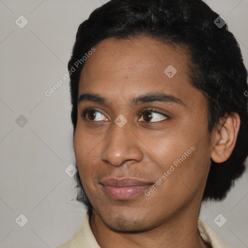 Joyful black young-adult male with short  black hair and brown eyes