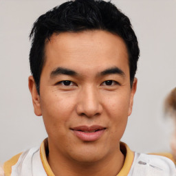 Joyful asian young-adult male with short  black hair and brown eyes