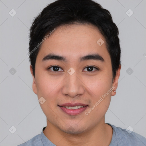 Joyful asian young-adult male with short  black hair and brown eyes