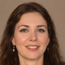 Joyful white young-adult female with long  brown hair and green eyes