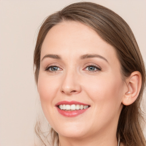 Joyful white young-adult female with long  brown hair and grey eyes