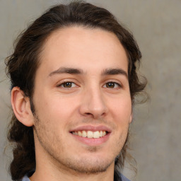 Joyful white young-adult male with medium  brown hair and brown eyes