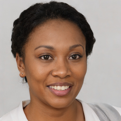 Joyful black young-adult female with short  brown hair and brown eyes