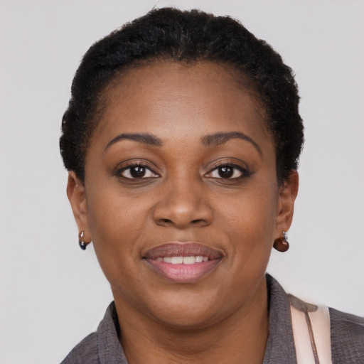 Joyful black young-adult female with short  brown hair and brown eyes