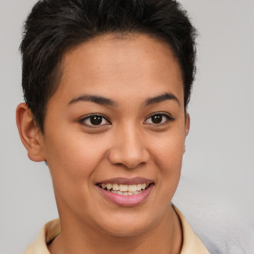 Joyful black young-adult female with short  brown hair and brown eyes