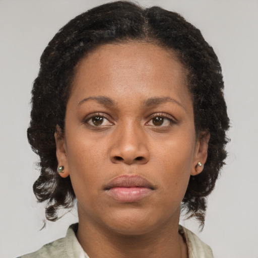 Neutral black young-adult female with medium  brown hair and brown eyes
