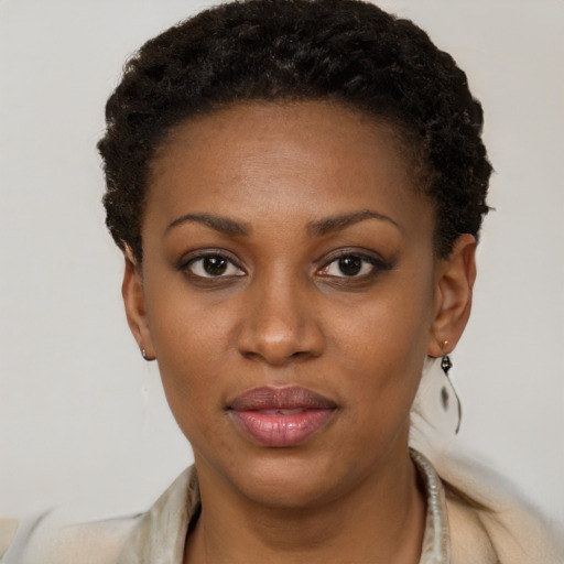 Joyful black young-adult female with short  brown hair and brown eyes