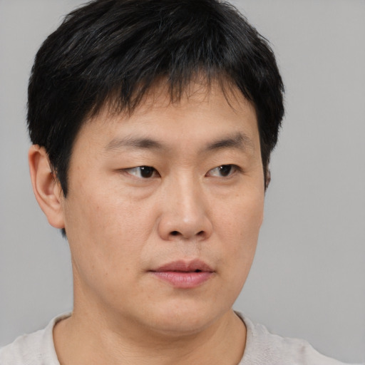 Neutral asian young-adult male with short  brown hair and brown eyes