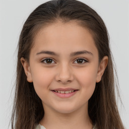 Joyful white child female with long  brown hair and brown eyes