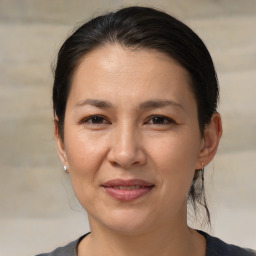 Joyful white adult female with medium  brown hair and brown eyes