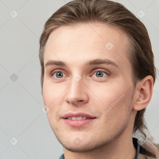 Joyful white young-adult male with short  brown hair and grey eyes