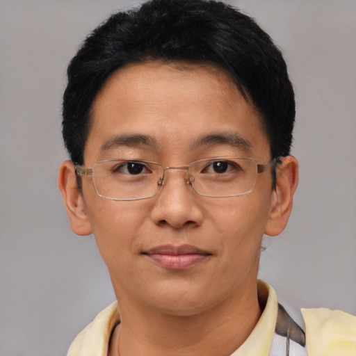 Joyful asian adult male with short  black hair and brown eyes
