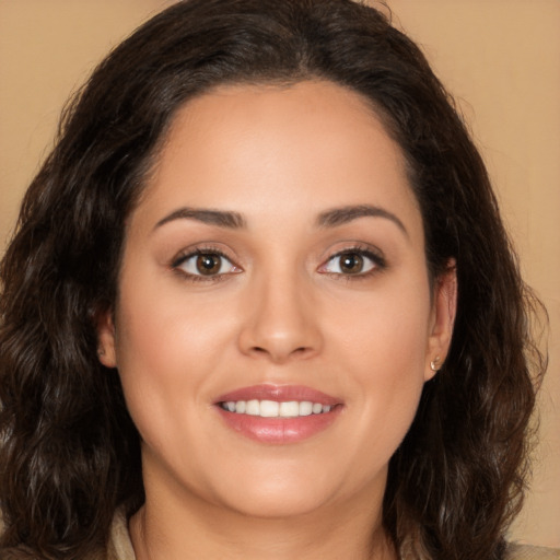 Joyful white young-adult female with long  brown hair and brown eyes