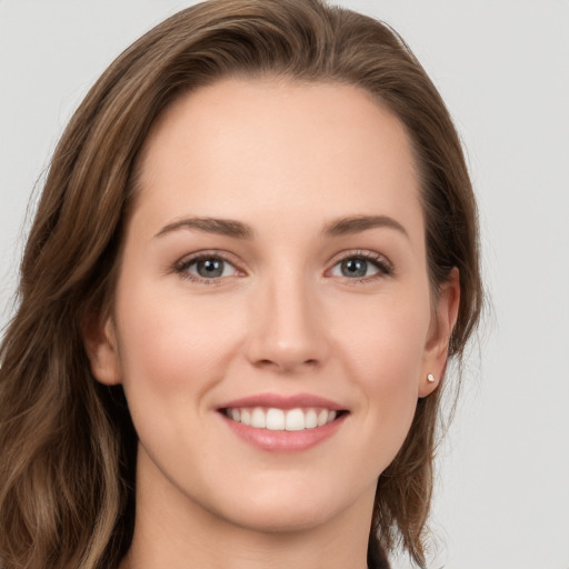 Joyful white young-adult female with long  brown hair and grey eyes