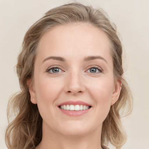 Joyful white young-adult female with long  brown hair and grey eyes