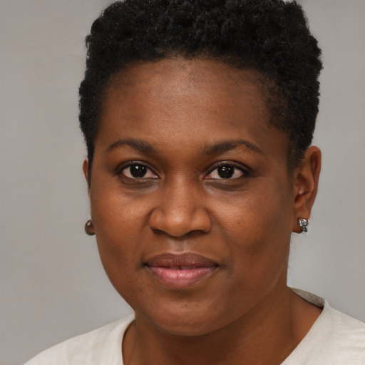 Joyful black young-adult female with short  brown hair and brown eyes