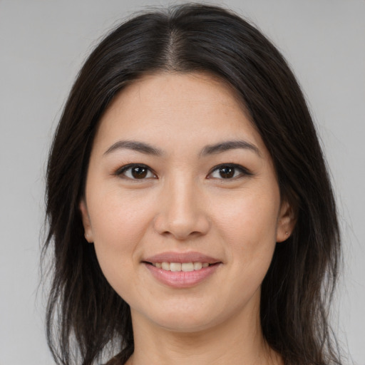 Joyful asian young-adult female with long  brown hair and brown eyes