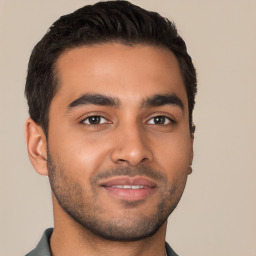 Joyful latino young-adult male with short  brown hair and brown eyes