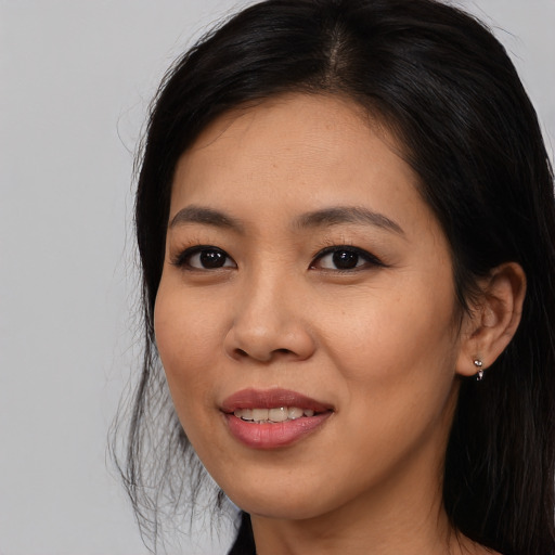 Joyful asian young-adult female with long  black hair and brown eyes