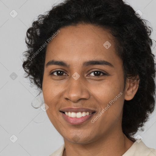 Joyful black young-adult female with long  brown hair and brown eyes