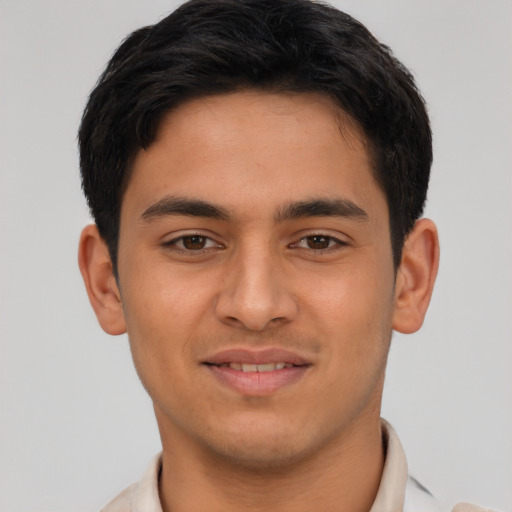 Joyful latino young-adult male with short  brown hair and brown eyes