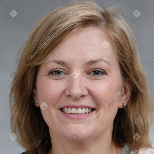 Joyful white adult female with medium  brown hair and blue eyes