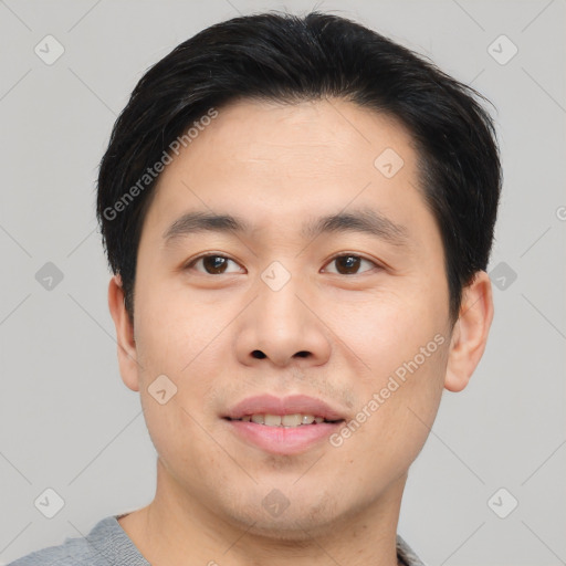 Joyful asian young-adult male with short  black hair and brown eyes