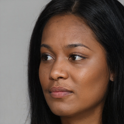 Joyful asian young-adult female with long  black hair and brown eyes