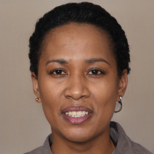 Joyful latino young-adult female with short  black hair and brown eyes