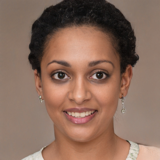 Joyful latino young-adult female with short  black hair and brown eyes