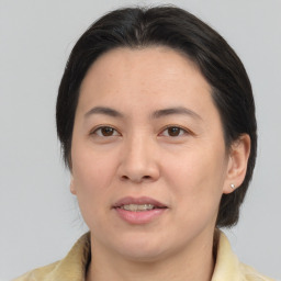 Joyful white adult female with medium  brown hair and brown eyes