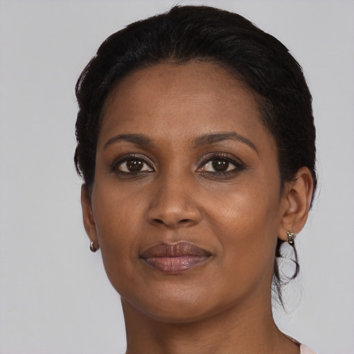 Joyful black adult female with short  black hair and brown eyes