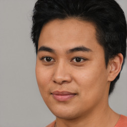 Joyful asian young-adult male with short  black hair and brown eyes