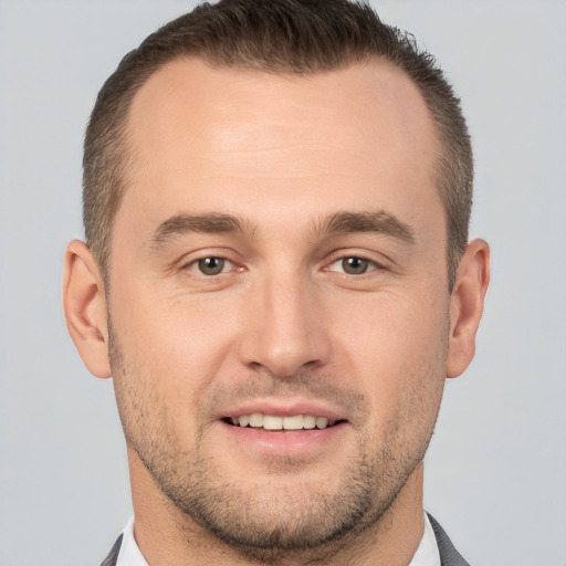 Joyful white young-adult male with short  brown hair and brown eyes