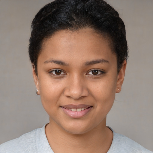 Joyful latino young-adult female with short  brown hair and brown eyes