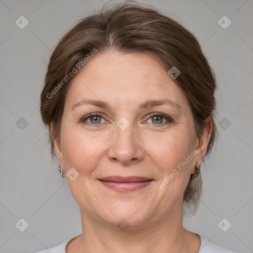 Joyful white adult female with medium  brown hair and grey eyes