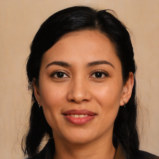Joyful latino young-adult female with long  black hair and brown eyes