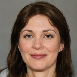 Joyful white adult female with medium  brown hair and brown eyes