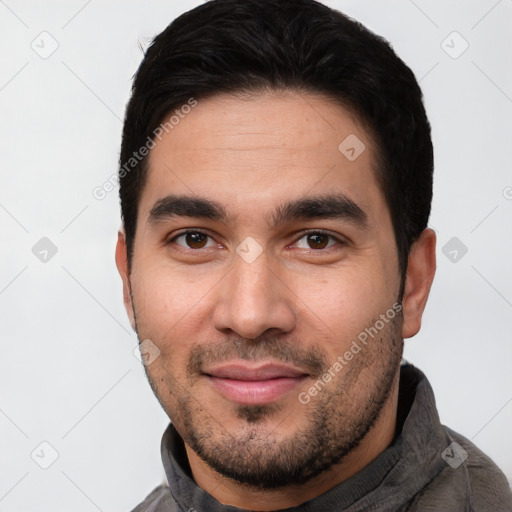 Joyful white young-adult male with short  black hair and brown eyes