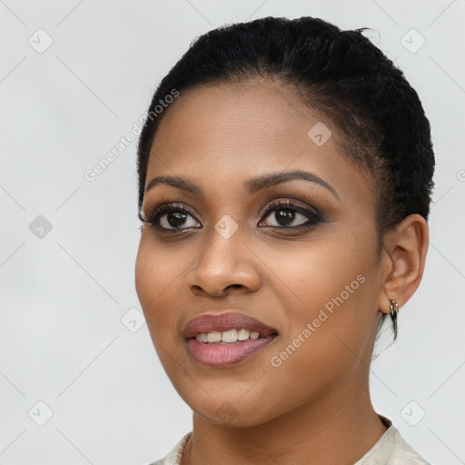 Joyful black young-adult female with short  brown hair and brown eyes