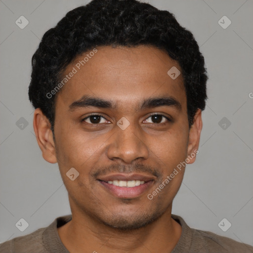 Joyful black young-adult male with short  black hair and brown eyes