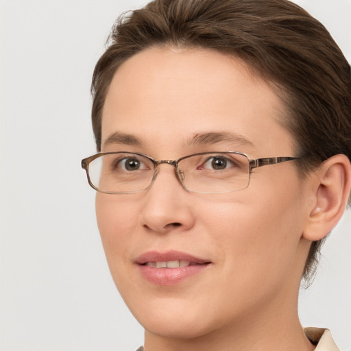 Joyful white adult female with short  brown hair and grey eyes